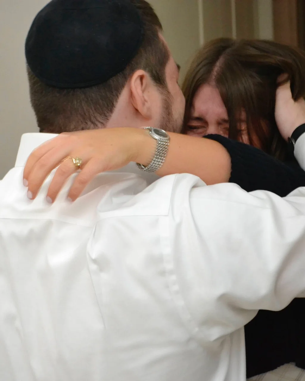 Leah in happy tears, hugging her brother the night of the proposal.